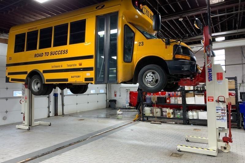 School Bus on Stertil-Koni Mobile Column Lifts with Multipurpose Adapters